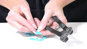 hands showing how to cut mosaic tiles with wheeled nippers