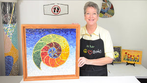 Lou Ann Weeks holding mosaic called Nautilus